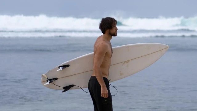 Surfer recovering after surfing in Bali by staying hydrated and resting